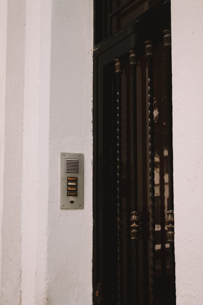 Pulsantiere citofoniche installate accanto a un ingresso residenziale